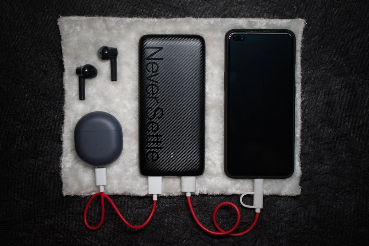 Electronic devices and charging cables on a dark surface