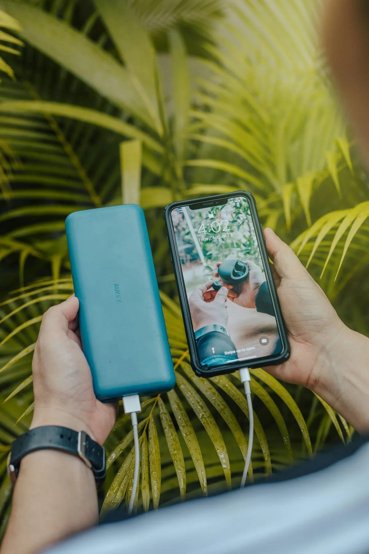 Smartphone connected to a power bank while traveling